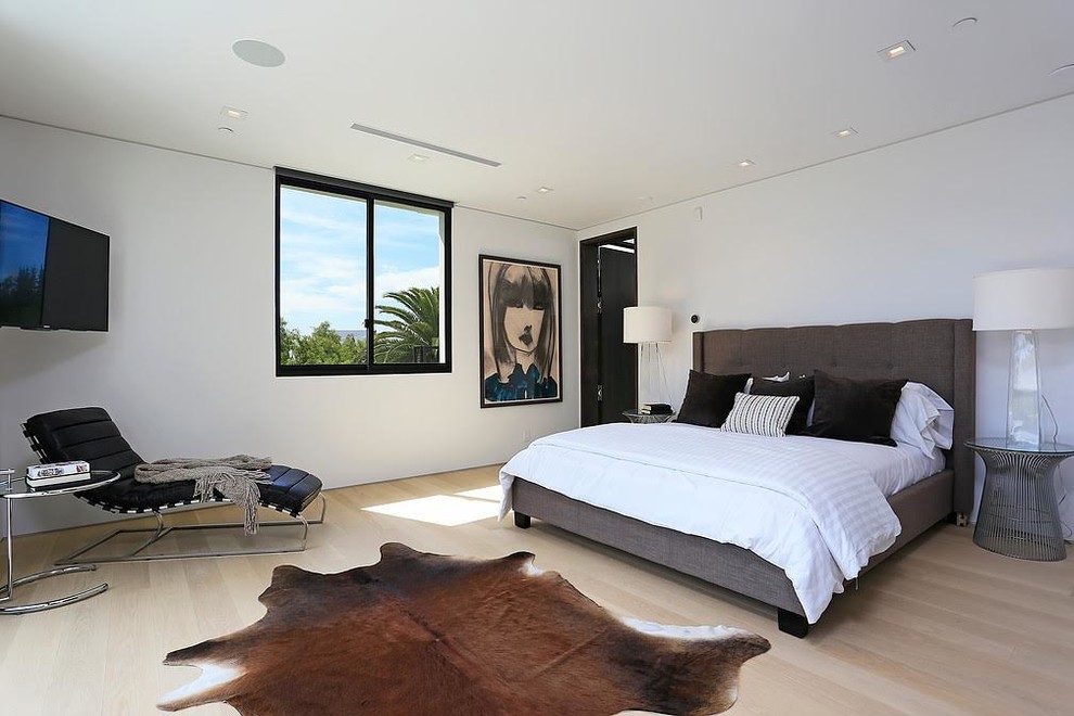 Example of a large trendy master light wood floor and beige floor bedroom design in Los Angeles with white walls and no fireplace