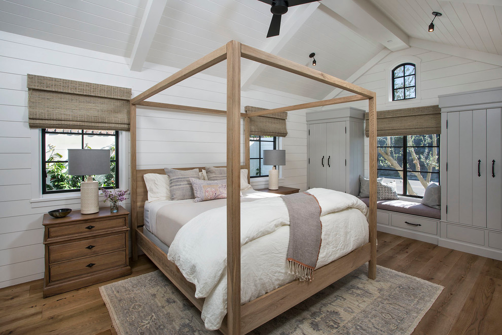Beach style master medium tone wood floor bedroom photo in Boise with white walls
