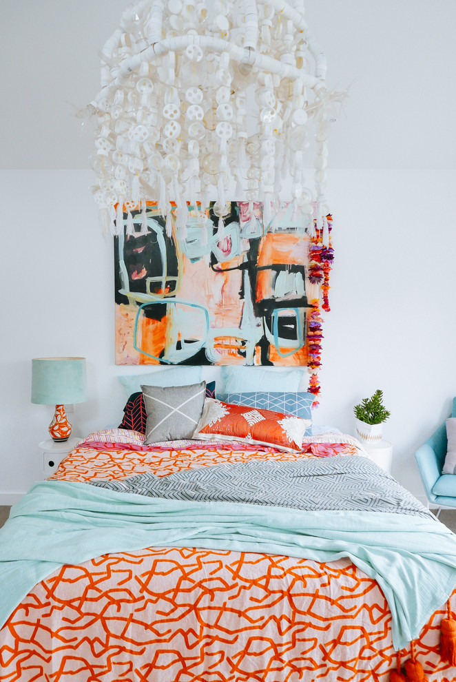 This is an example of a bohemian bedroom in Sydney with white walls.