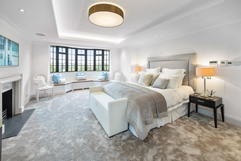 ロンドンにあるトランジショナルスタイルのおしゃれな主寝室 (白い壁、カーペット敷き、標準型暖炉、ベージュの床)
