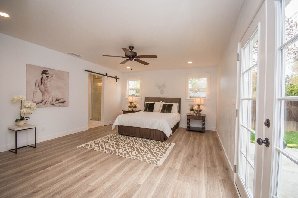 Medium sized contemporary master bedroom in Orange County with white walls, medium hardwood flooring, no fireplace and beige floors.
