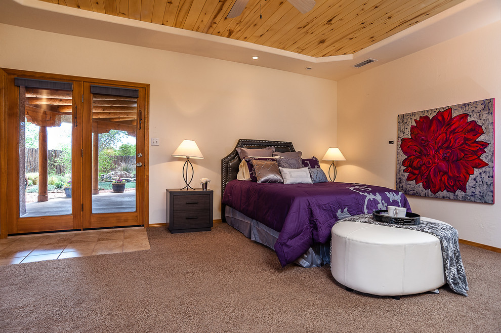 Inspiration for an expansive master bedroom in Albuquerque with white walls and carpet.