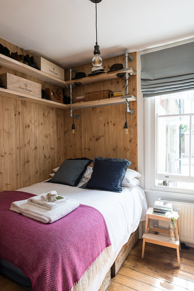 This is an example of a rustic bedroom in London with light hardwood flooring.