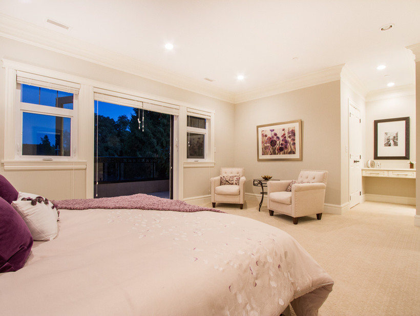 Example of a large transitional master carpeted bedroom design in Vancouver with beige walls