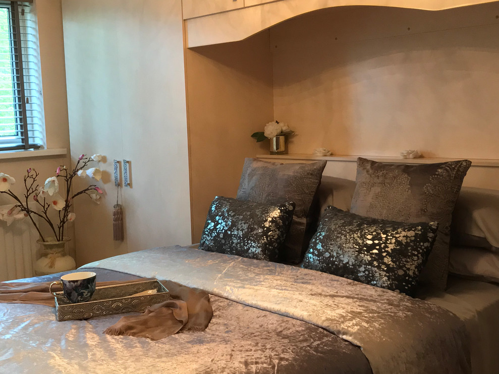 Foto di una camera da letto contemporanea di medie dimensioni con pareti beige, pavimento in laminato e pavimento beige