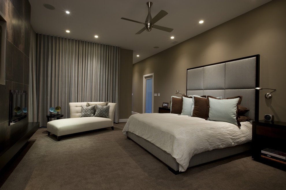 This is an example of a contemporary master bedroom in Chicago with carpet and brown walls.