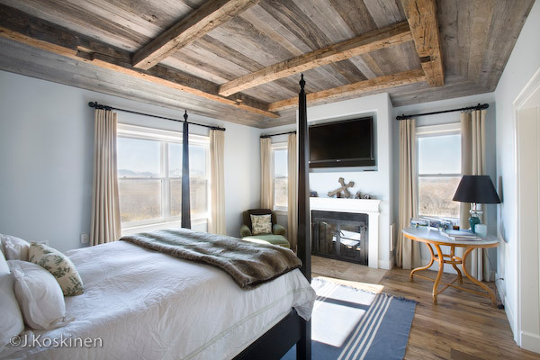 Inspiration for a medium sized contemporary master bedroom in Denver with blue walls, dark hardwood flooring, a standard fireplace and a metal fireplace surround.