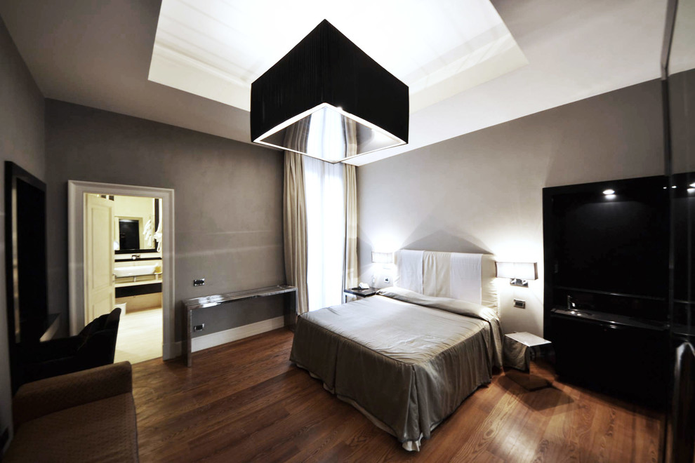 Großes Modernes Hauptschlafzimmer mit grauer Wandfarbe und braunem Holzboden in Rom