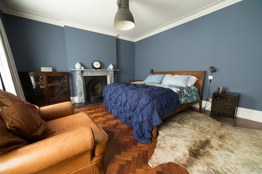 This is an example of a large rustic master bedroom in Other with blue walls.