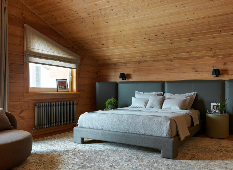 Immagine di una camera da letto rustica con pareti marroni, pavimento in legno massello medio, pavimento marrone, soffitto a volta, soffitto in legno e pareti in legno