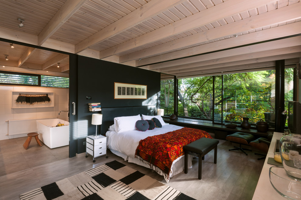 Идея дизайна: большая хозяйская спальня в современном стиле с черными стенами и полом из ламината без камина