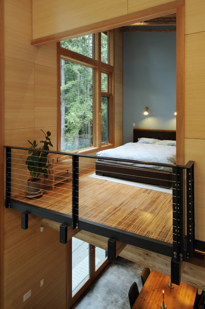 Example of a mid-sized trendy loft-style bamboo floor bedroom design in Seattle with blue walls and no fireplace