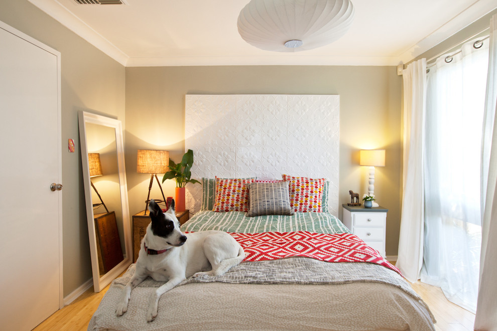 Example of a mid-sized trendy master medium tone wood floor bedroom design in Perth with beige walls
