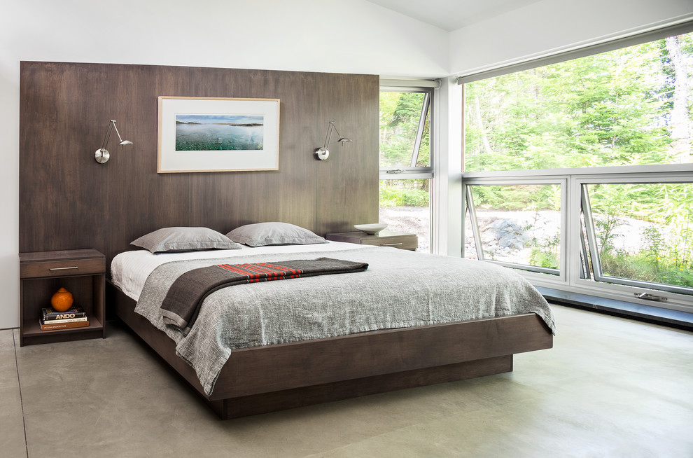 Пример оригинального дизайна: большая хозяйская спальня в современном стиле с белыми стенами и бетонным полом без камина