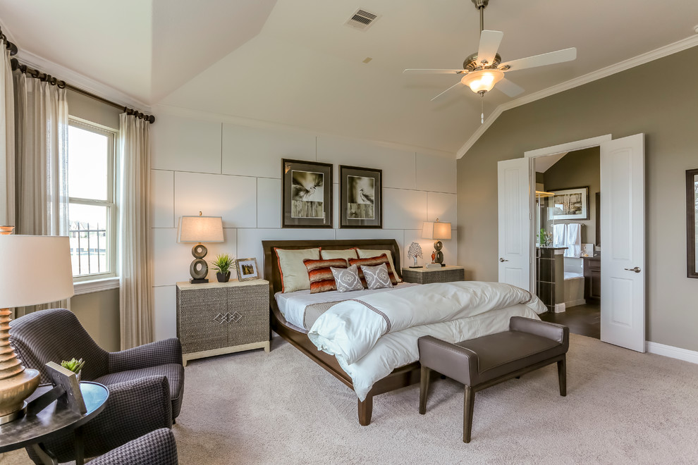 Inspiration for a large traditional master bedroom in Houston with beige walls and carpet.