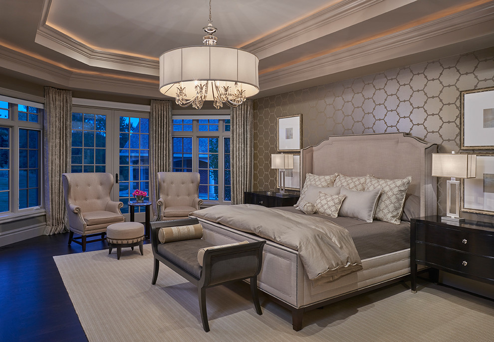 Expansive classic master bedroom in Detroit with beige walls and dark hardwood flooring.