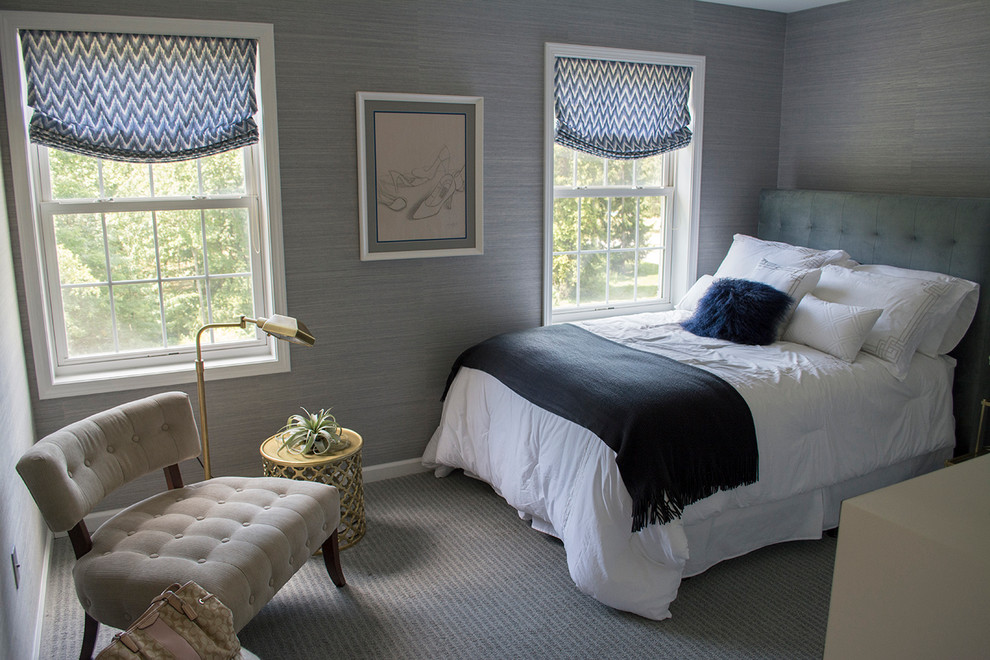 Example of a mid-sized transitional guest carpeted bedroom design in New York with blue walls and no fireplace