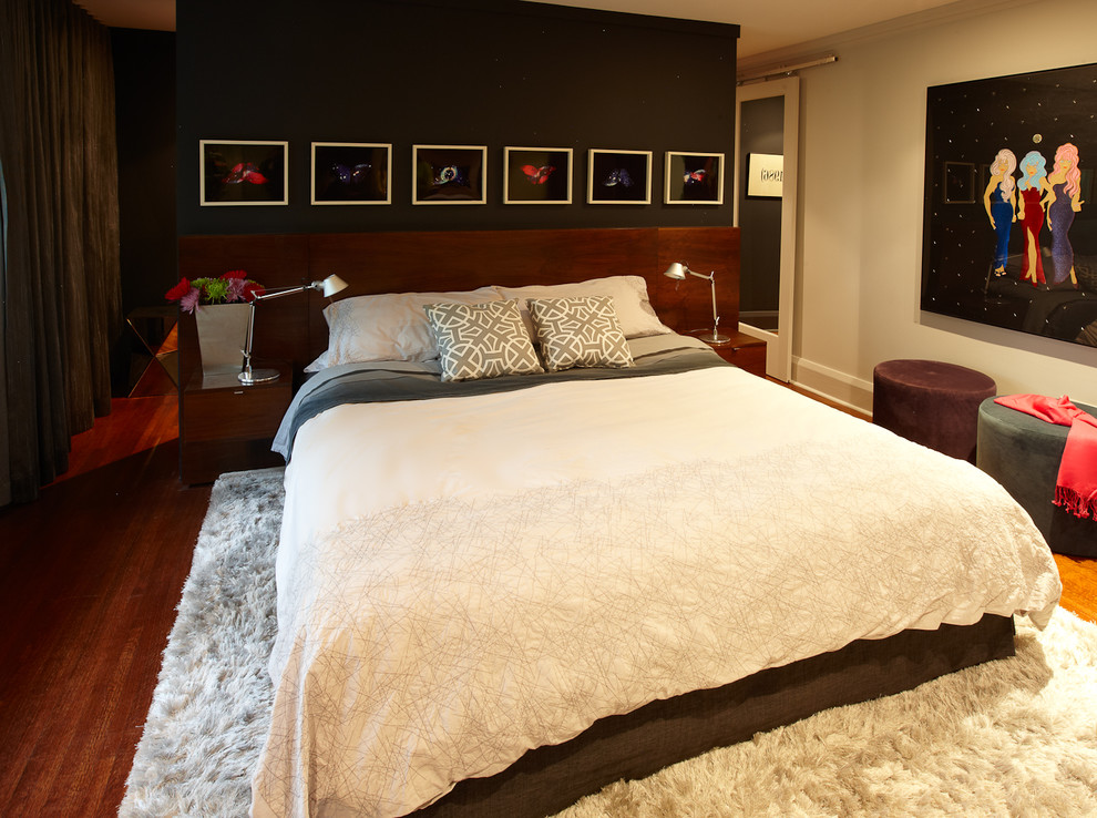 Large contemporary master bedroom in Toronto with grey walls and medium hardwood flooring.