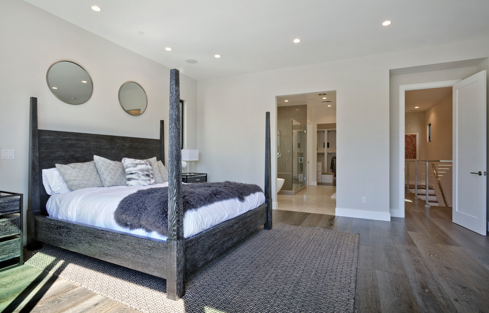 Design ideas for a medium sized modern master bedroom in Orange County with grey walls, medium hardwood flooring, grey floors, a metal fireplace surround and a ribbon fireplace.