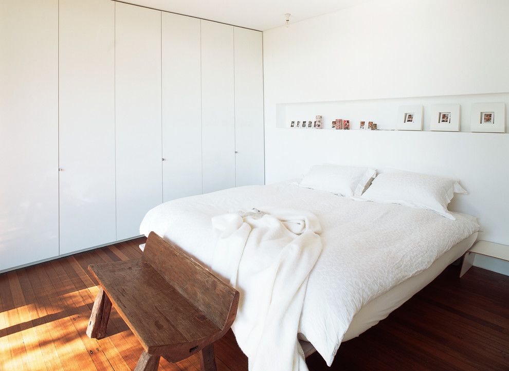 На фото: гостевая спальня среднего размера, (комната для гостей) в скандинавском стиле с белыми стенами и темным паркетным полом без камина с