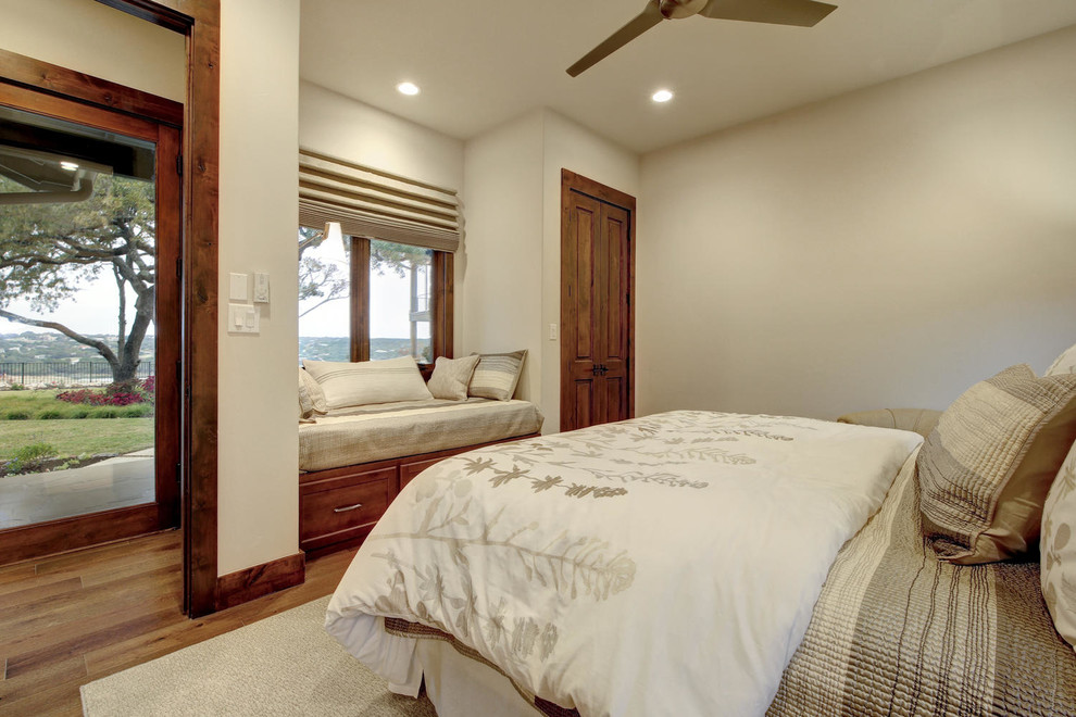 Ejemplo de habitación de invitados tradicional renovada grande sin chimenea con paredes blancas, suelo de madera en tonos medios y suelo beige