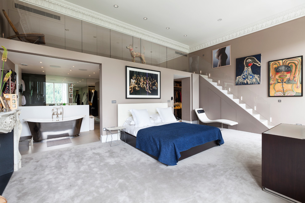 Inspiration for an expansive contemporary master and grey and silver bedroom in London with carpet and grey walls.