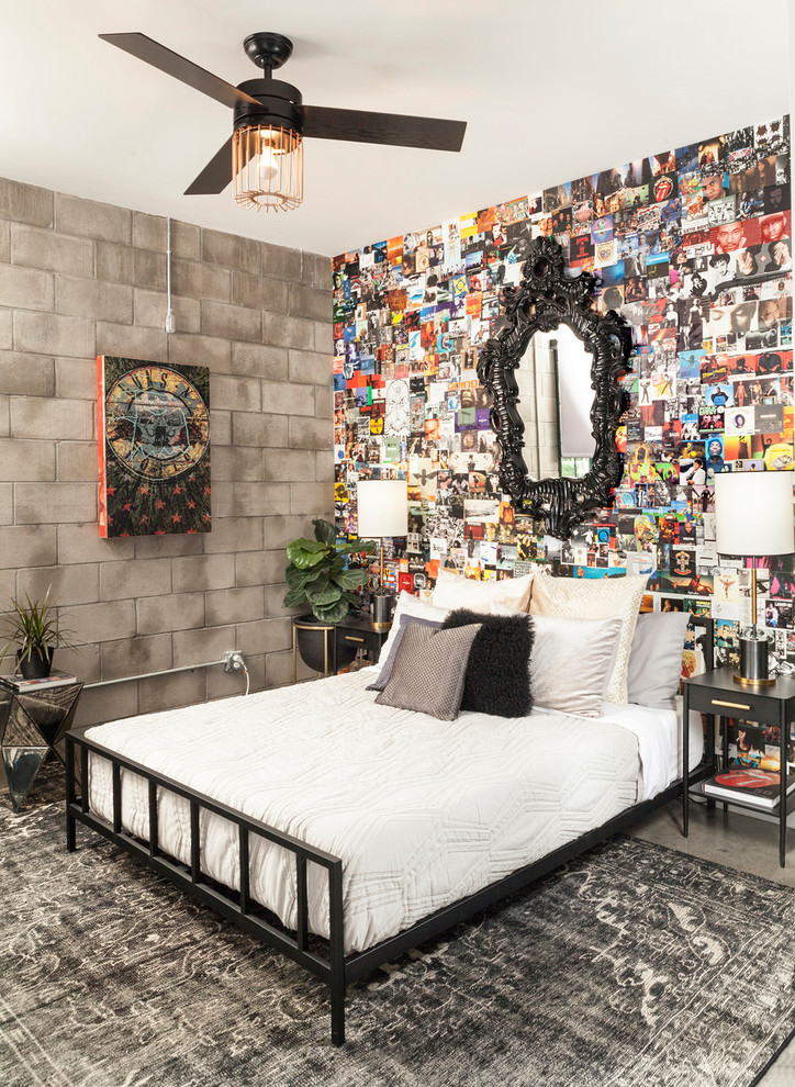 Immagine di una camera da letto industriale con pareti multicolore, nessun camino e pavimento grigio