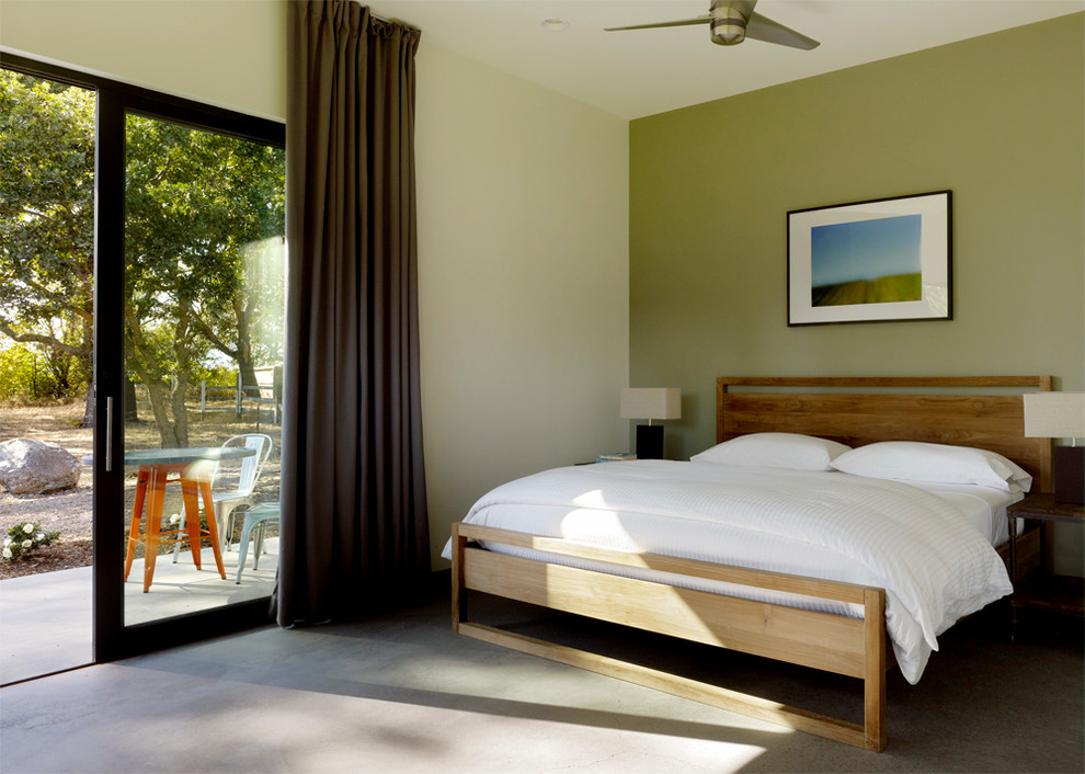 Ejemplo de dormitorio minimalista con suelo de cemento