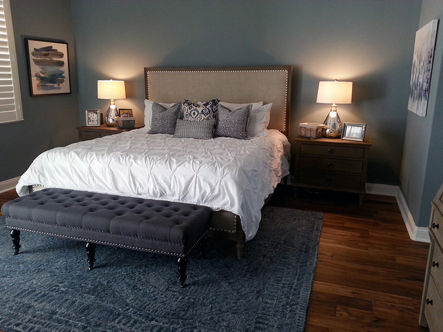 Example of a large transitional master porcelain tile and brown floor bedroom design in Orlando with blue walls