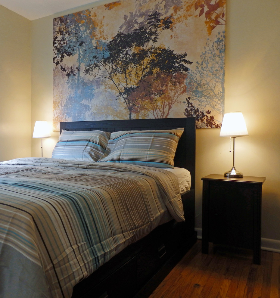 Small modern master bedroom in Toronto with beige walls and medium hardwood flooring.