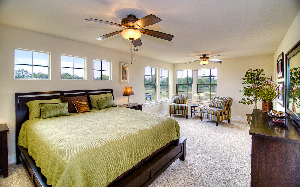 Contemporary bedroom in Austin with beige walls and carpet.