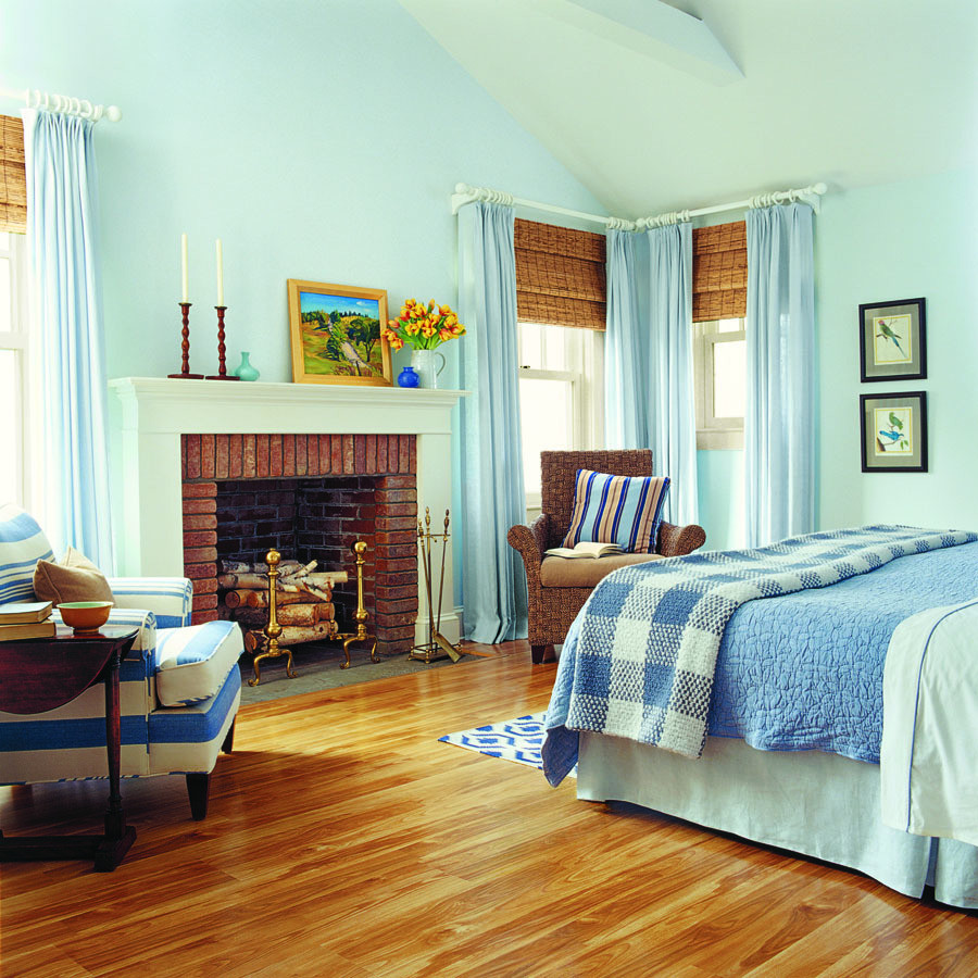 Mittelgroßes Landhaus Gästezimmer mit blauer Wandfarbe, Laminat, Kamin und Kaminumrandung aus Backstein in Denver