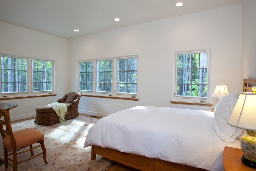 Contemporary guest bedroom in Other with white walls and light hardwood flooring.