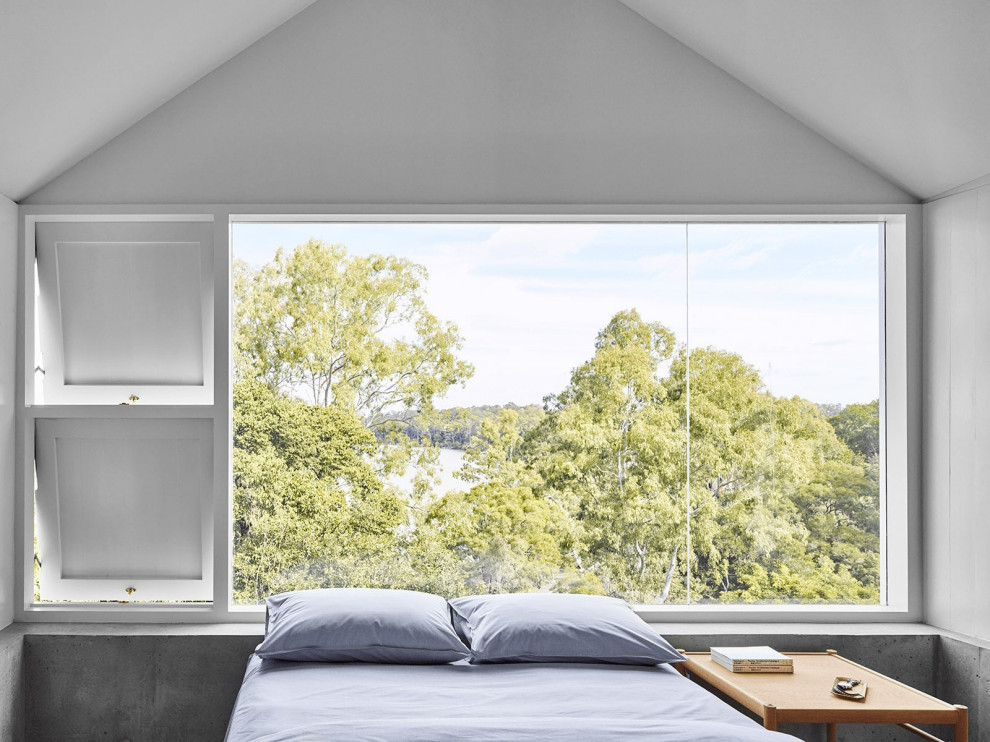 Photo of a coastal bedroom in Brisbane with white walls, no fireplace and a vaulted ceiling.