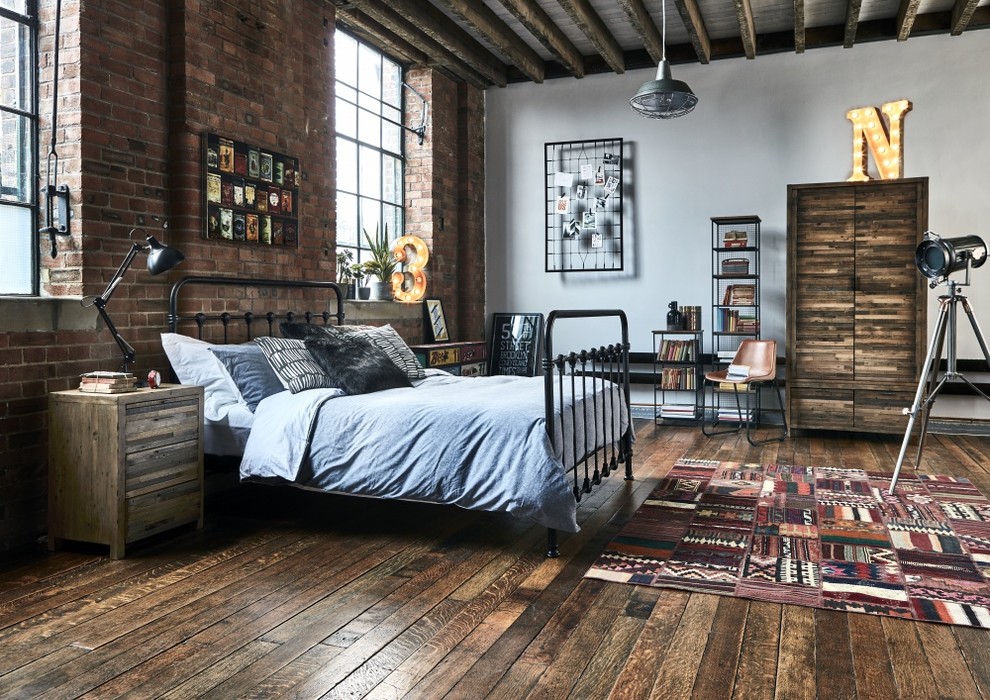 Industrial master bedroom in Other with white walls, dark hardwood flooring and brown floors.