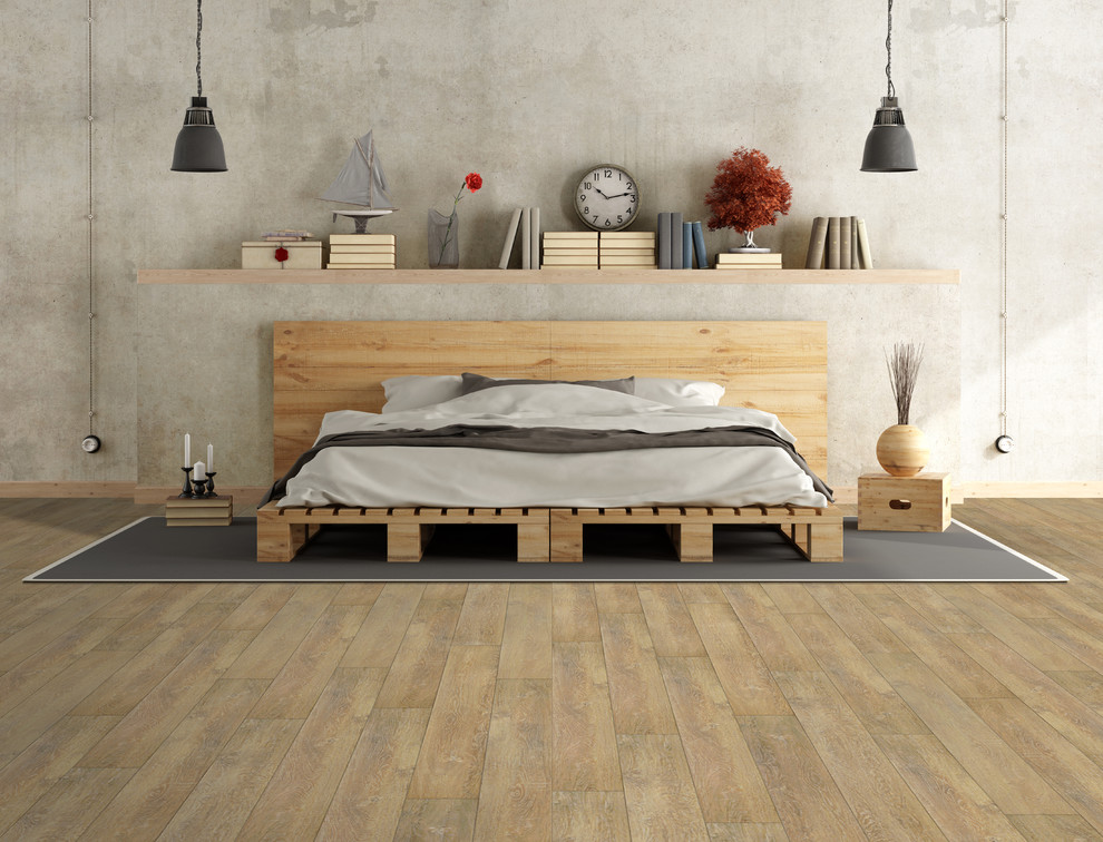 Ispirazione per una camera da letto industriale con pavimento in vinile