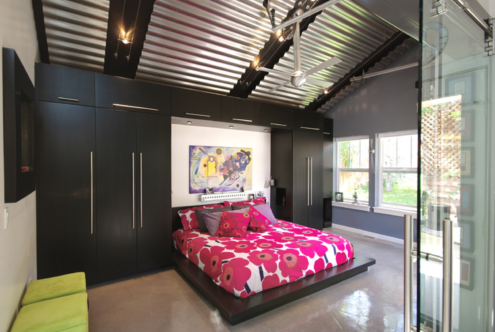Idée de décoration pour une chambre grise et rose design avec sol en béton ciré.