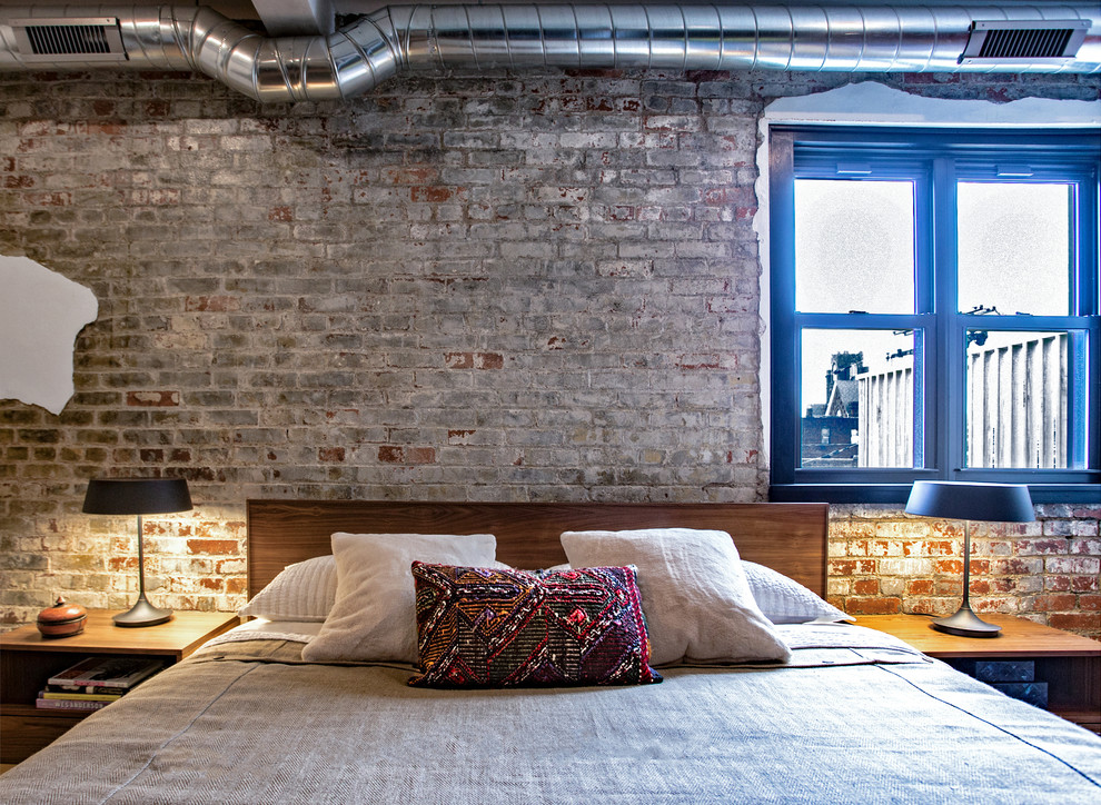 На фото: хозяйская спальня среднего размера в стиле лофт с серыми стенами без камина с