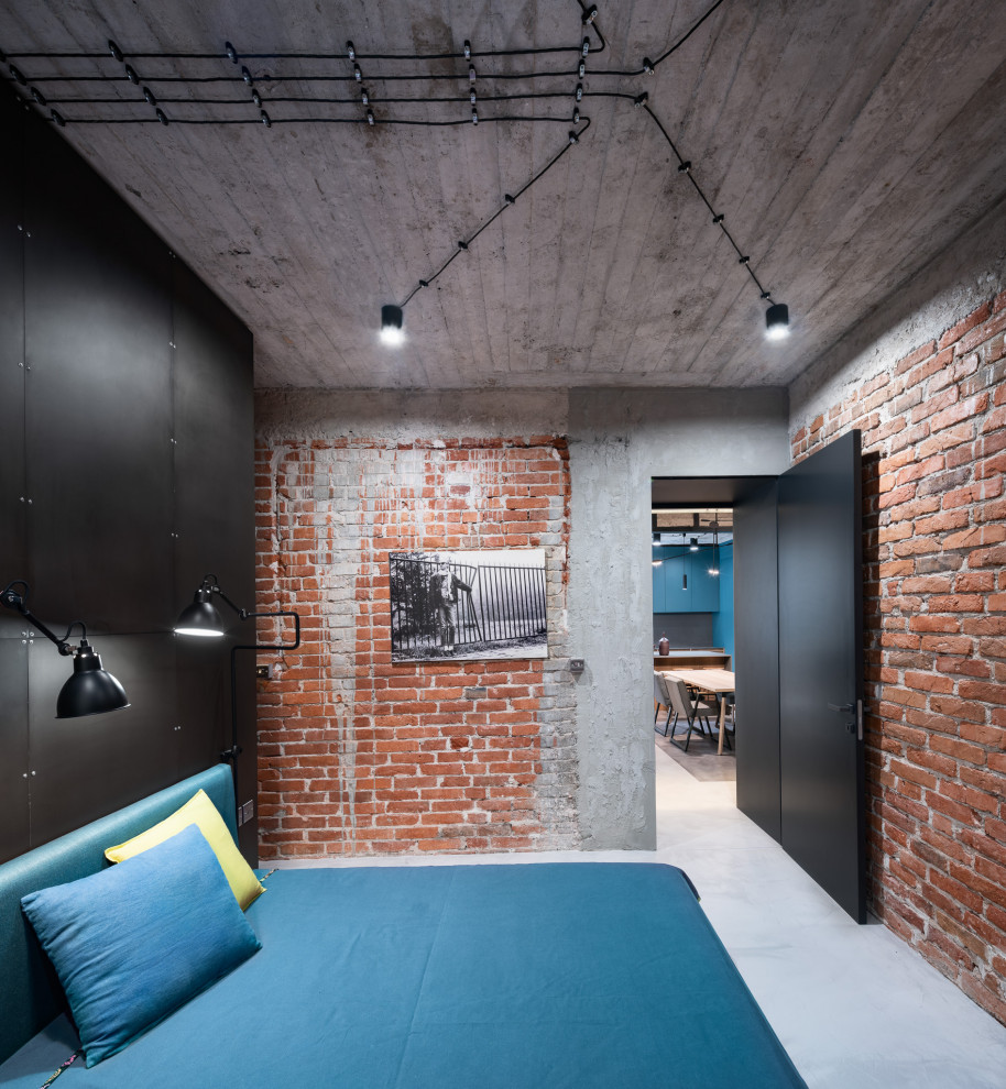 Immagine di una camera da letto industriale di medie dimensioni con pareti nere e pavimento grigio