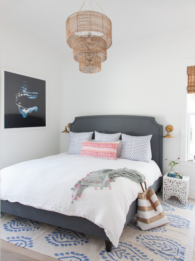 This is an example of a coastal bedroom in Miami with white walls.