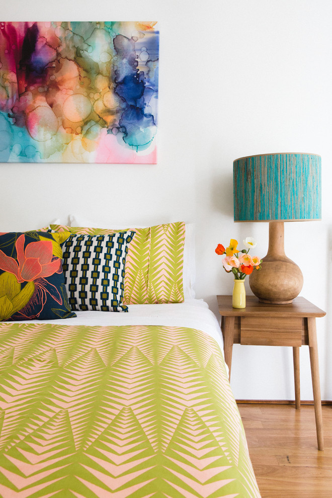 Inspiration for a small contemporary master medium tone wood floor bedroom remodel in Sydney with white walls and no fireplace