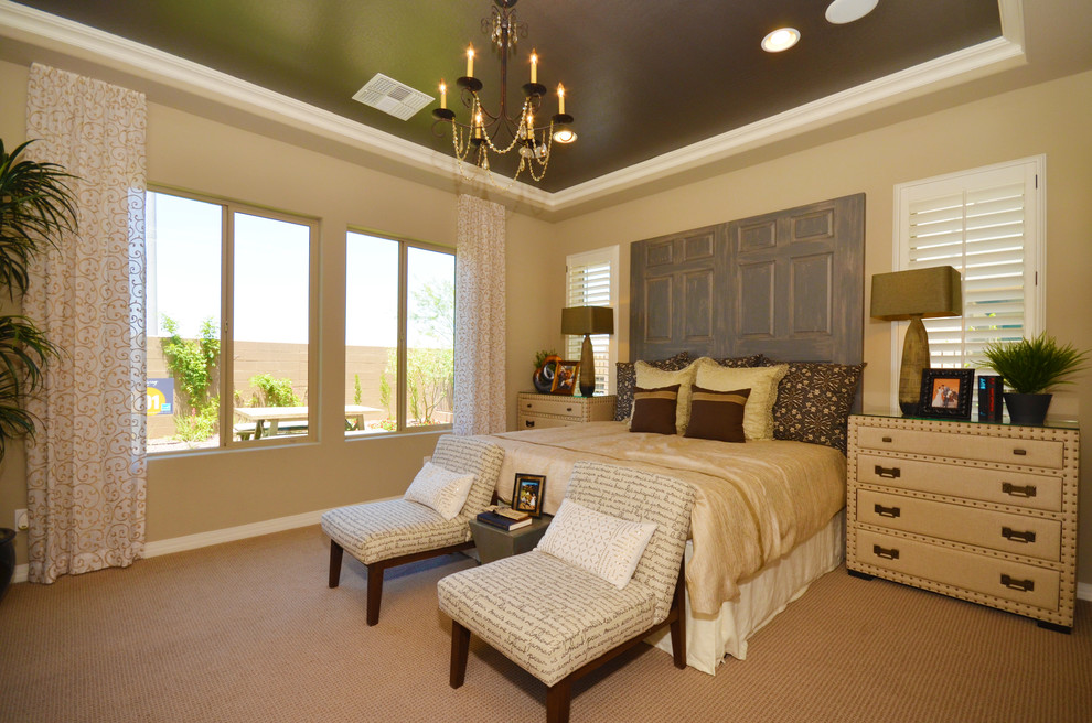 Large mediterranean master bedroom in Phoenix with beige walls and carpet.