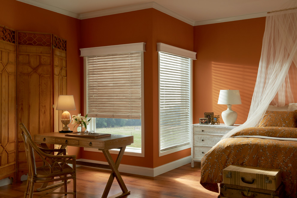 Пример оригинального дизайна: большая хозяйская спальня в стиле неоклассика (современная классика) с оранжевыми стенами, паркетным полом среднего тона и коричневым полом без камина