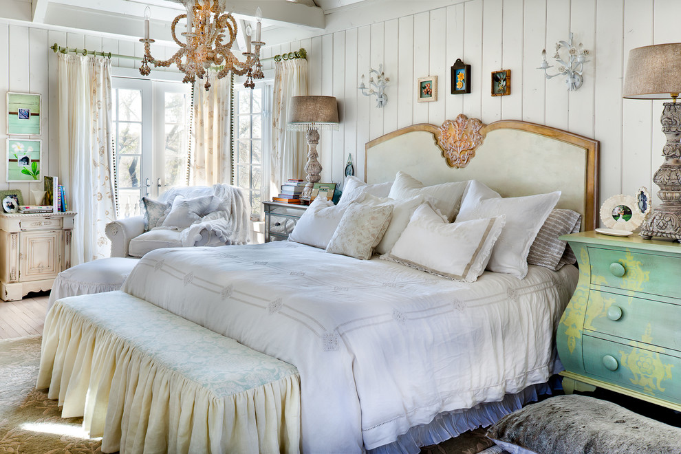 Example of a cottage chic light wood floor bedroom design in Kansas City with white walls and no fireplace