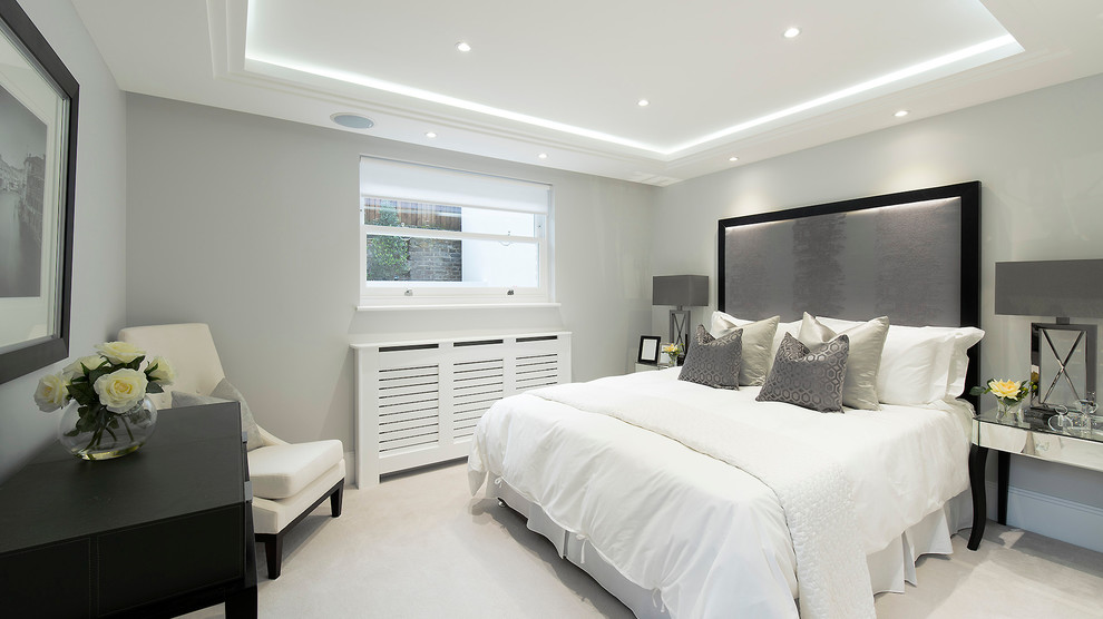 Bedroom - contemporary bedroom idea in London with gray walls