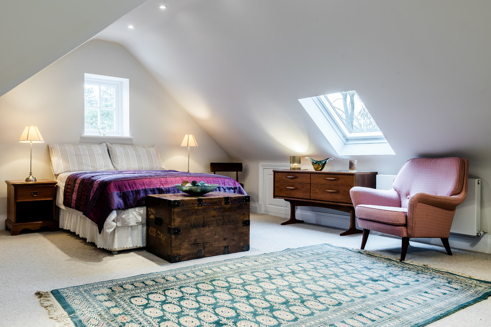 Medium sized contemporary guest loft bedroom in London with white walls and carpet.