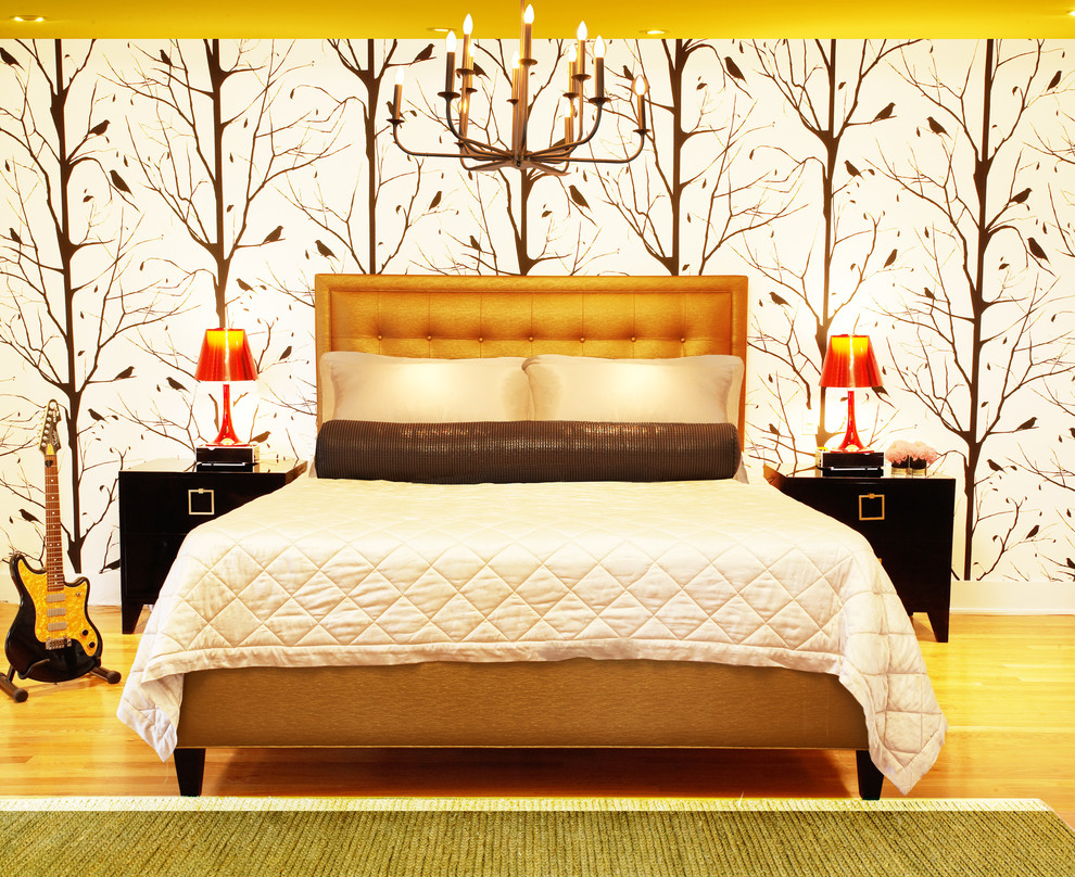 Foto di una grande camera matrimoniale design con pareti gialle e pavimento in legno massello medio