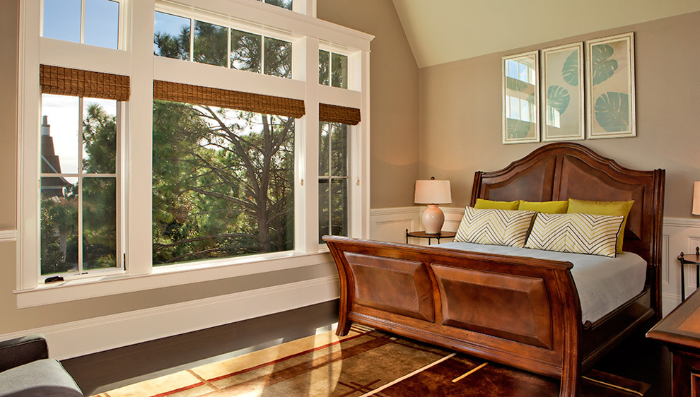 Example of a mid-sized classic guest dark wood floor bedroom design in Charleston with beige walls and no fireplace