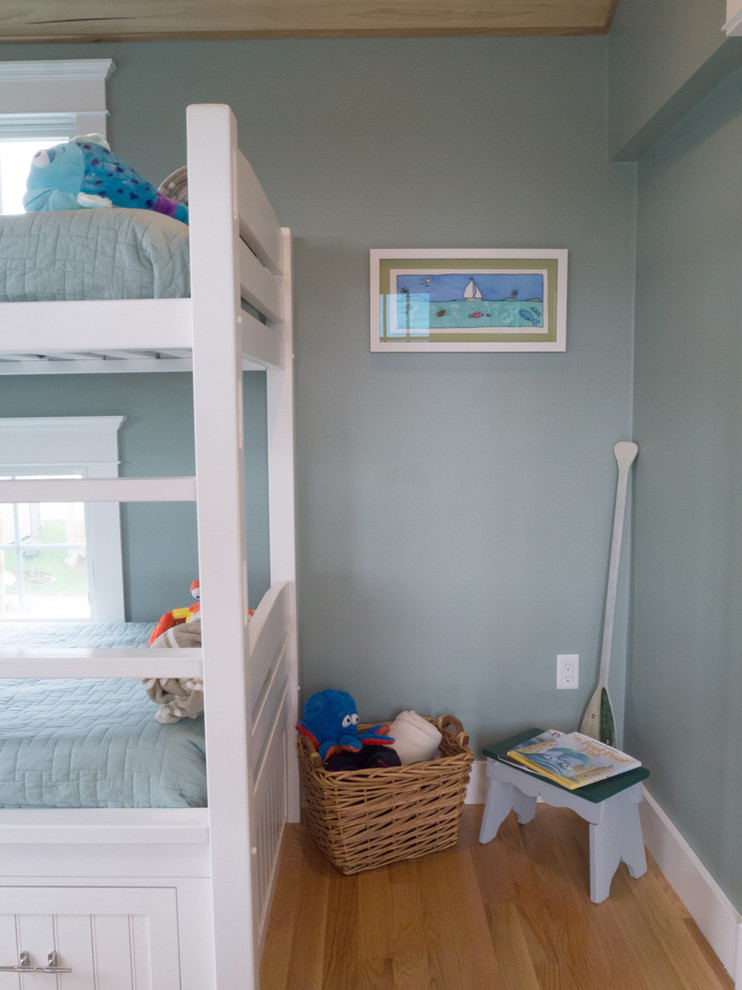 Mid-sized beach style guest light wood floor bedroom photo in Providence with blue walls