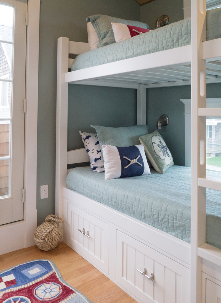 Medium sized nautical guest bedroom in Providence with blue walls and light hardwood flooring.